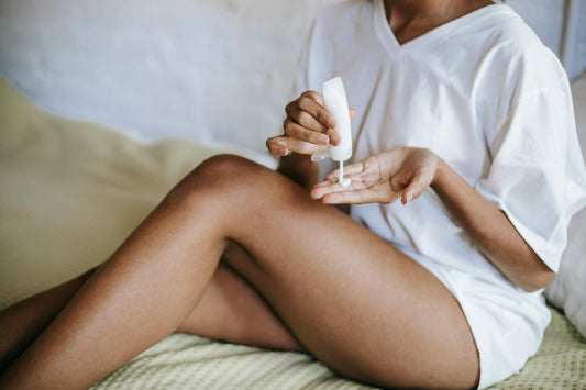 Woman applying tallow-based self tanner on legs using clean skincare cream | Tallowtan™ barrier-safe formula