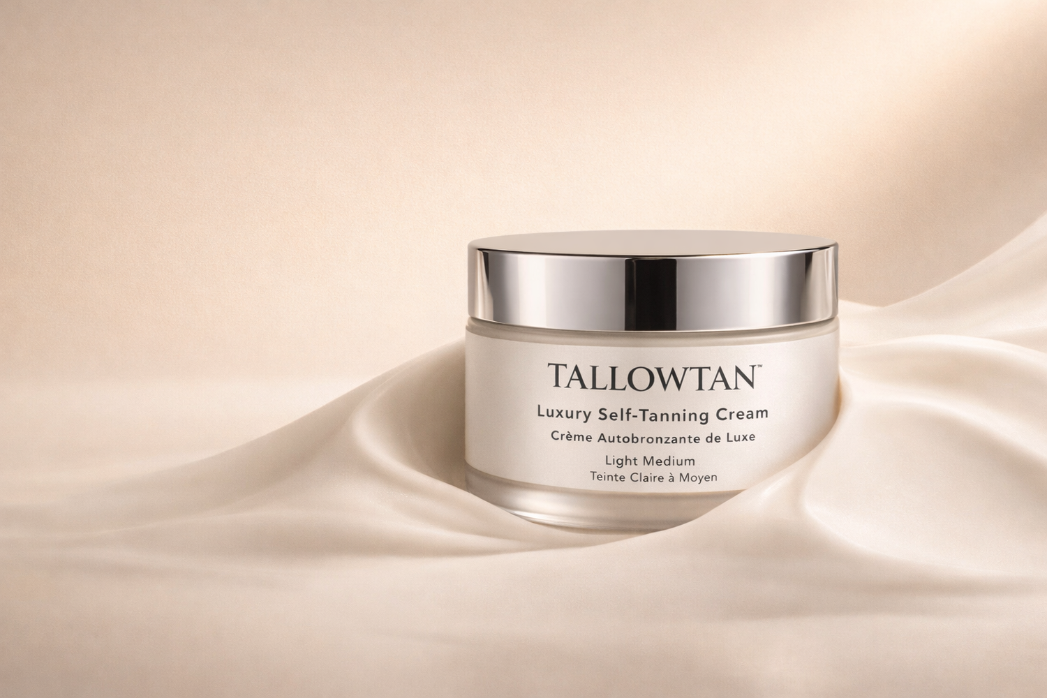 Tallowtan luxury self-tanning cream in frosted glass jar with soft natural glow finish on champagne background
