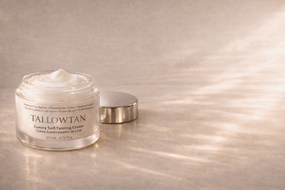 Open jar of Tallowtan tallow self tanning cream with the lid beside it in natural light