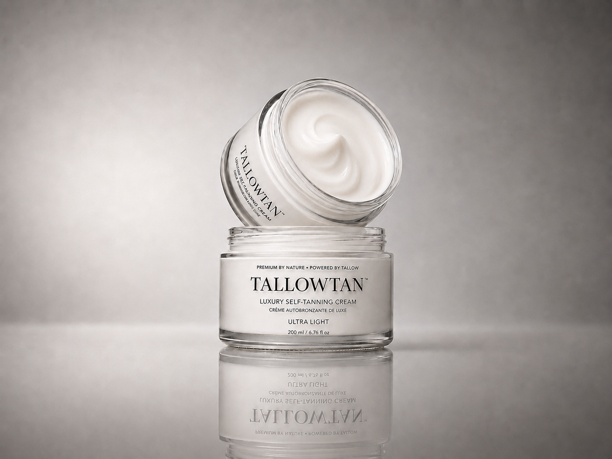 Tallowtan Ultra Light self tanner jars stacked on a reflective surface, lid tilted open