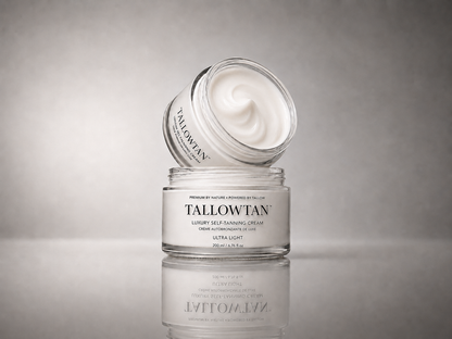 Tallowtan Ultra Light self tanner jars stacked on a reflective surface, lid tilted open